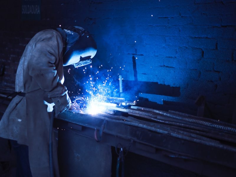 man-wearing-welding-helmet-welding-metal-near-gray-brick-1474993